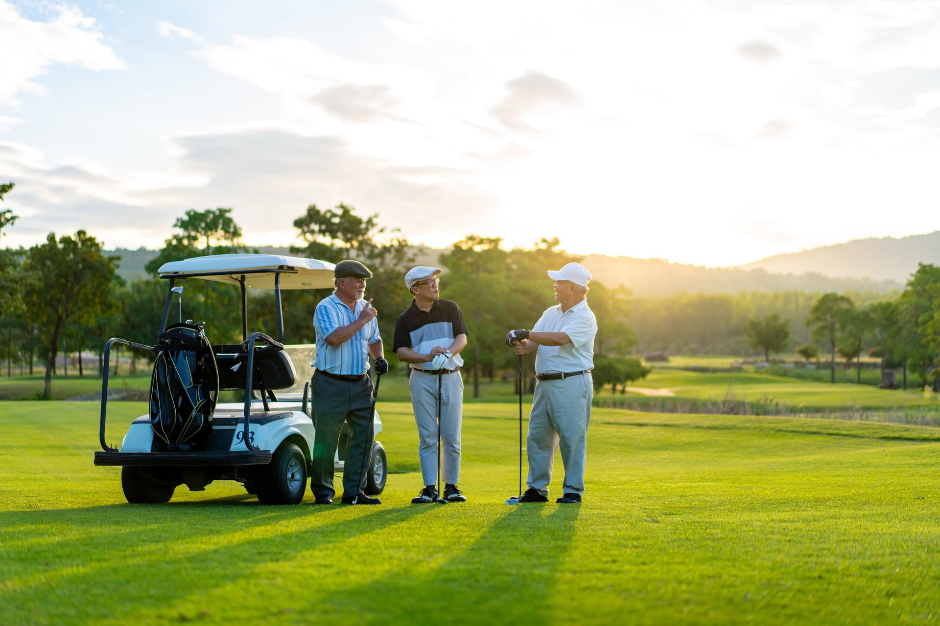 Group of Asian people businessman and senior CEO enjoy outdoor sport lifestyle golfing together at golf country club