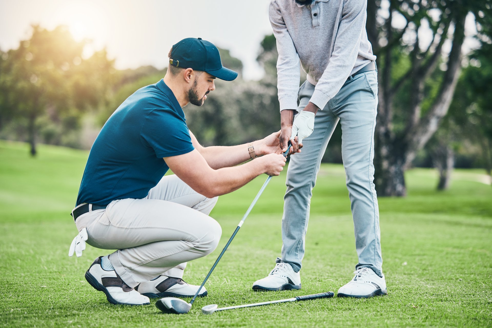 Golf lesson, teaching and sports coach help man with swing, putt and stroke outdoor